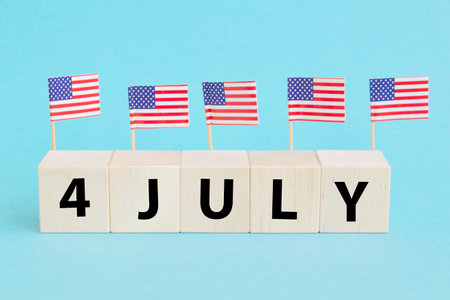 4th of July American Independence Day. Happy Independence Day. Wood cubes with lettering on blue backgroundの写真素材