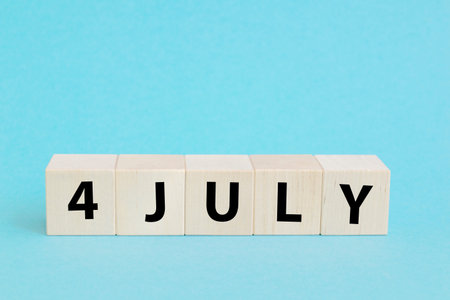 4th of July American Independence Day. Happy Independence Day. Wood cubes with lettering on blue backgroundの写真素材