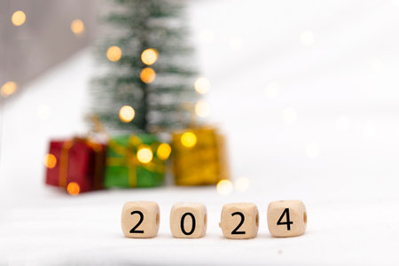 Decorative blue gift box on white background with bokeh of lights and numbers of year 2024の写真素材