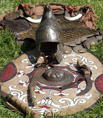 Ancient helmet, shield and weapon on displayの写真素材