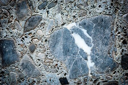 Concrete different gray stone surface. Grey masonry, stonework texture. Rock gloomy pattern background. Abstract damaged urban dirty rough grainy stone wallの写真素材