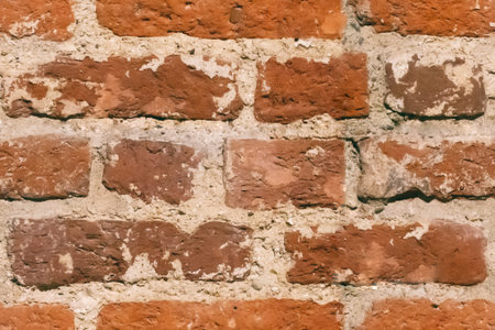 Orange brick wall texture background. Pattern of weathered old cracked brickwall. Stacked stones...