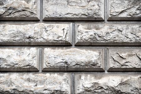 Rock gloomy pattern background. Grey masonry, stonework texture. Concrete different gray stone surface. Geometric aged urban dirty rough grainy stone wall. Brick patternの写真素材