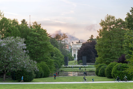 Milan, Italy - May 4, 2020: people exercising, bicycling, walking outdoor, in central Sempione park...