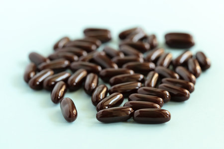 Medical pills and capsules. Brown medication on blue background. Pharmacy, healthcare, health...