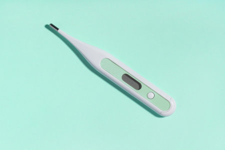 Medical electronic thermometer on blue background. Medicine, healthcare concept. Diagnostic equipment for measuring temperature. Medical device.の写真素材