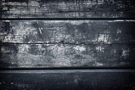 Rough wooden painted floor boards surface. Shabby wood texture covered by aged cracked painting. Distressed pattern. Damaged grey backdrop. Old village wooden wall.の写真素材