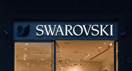 Swarovski luxury fashion store exterior logo in Como. Swarovski Crystal range includes fine jewelry, elegant watches and sparkling crystal creations. Como, Italy - 10.11.2019のeditorial素材