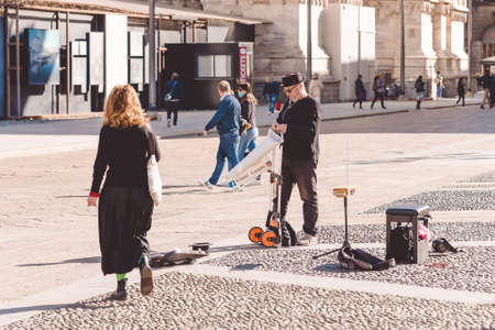 Street musician Gianni Guaglio is going to play the theremin near Duomo cathedral. Milan city during coronavirus on a sunny day, Covid 19 outbreak. Milan, Italy - September 27, 2020のeditorial素材
