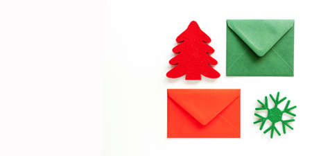 Set of christmas envelopes and felt decoration on white. Banner design, top view, flat lay, copy space.の写真素材