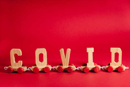 Transportation during coronavirus outbreak concept. Train on red backdrop. Novel corona virus outbreak. Covid pandemic concept.の写真素材