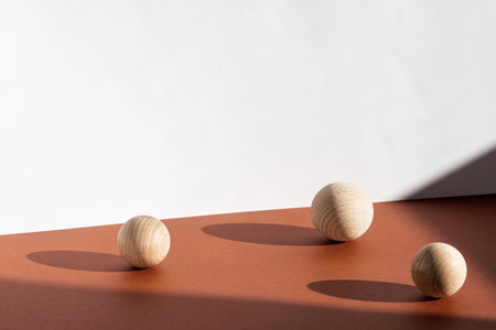Modern product presentation background with wooden decor, shadows and light from window. Natural shadow overlay trendy effect on brown surface tabletop.の写真素材