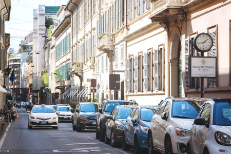 Milan, Italy - September 24, 2020. Cars parked along way. Taxi car driving through the shopping...