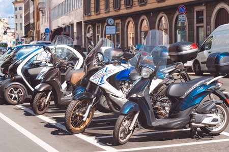 Motorcycles parked in a row in european city center. Motorbike group parking on street during adventure journey. Motorcyclists commuter or commuting concept. Milan, Italy - September 24, 2020.のeditorial素材