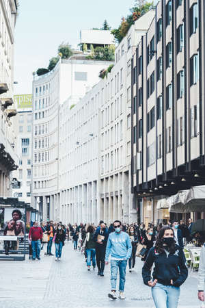 Milan, Italy - September 24, 2020. People walking downtown in facial medical masks. New normal. People wearing face mask and maintain social distancing. Italy in coronavirus COVID-19 lockdownのeditorial素材