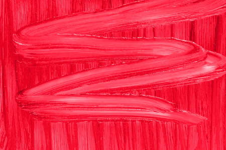 Makeup creamy backdrop. Liquid beauty cream close up. Red lipstick smear smudge sample texture background. Beauty product lop gloss closeup.の写真素材