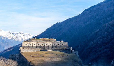 Exilles Fort is a fortified complex in the Susa Valley, Metropolitan City of Turin, Piedmont, northern Italy. Medieval fortress wall towers view. Medieval fort landmark. Fortress on winter sunny day.の写真素材