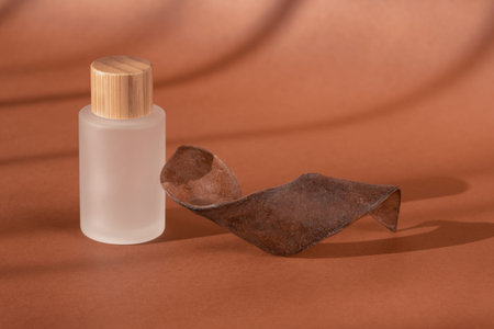 Cream beauty skincare cosmetic mockup showcase, shadow from sun. Product presentation, cosmetics brand, lotion, peptide, collagen, hyaluronic acid in glass bottle, wooden decor. Minimal templateの写真素材