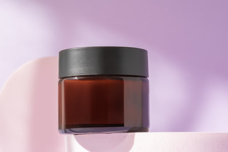 Organic face cream cosmetic mock up on podium, low angle view, copy space. Blank jar of luxury lotion in brown bottle standing on pedestal showcase. Beauty packaging mockup product presentationの写真素材