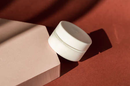 Product presentation, cosmetics brand, lotion, peptide, collagen, hyaluronic acid in white plastic jar. Cream beauty skincare cosmetic mockup showcase, shadow from sun. Minimal templateの写真素材