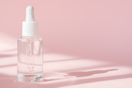 Hyaluronic acid oil, serum with collagen and peptides skin care product on background with shadows. Cosmetic liquid mockup in transparent bottle. Mock up packaging, cosmetics design branding.の写真素材