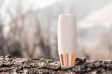 Foundation mock up bottle on natural wooden bark background. Facial concealer tube mockup. Bio organic cosmetic makeup beauty product. Front viewの写真素材