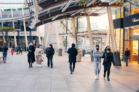 Milan, Italy - November 02, 2020: people, pedestrian walking in Garibaldi district in Milan, doing shopping. People wearing face mask and maintain social distancingのeditorial素材