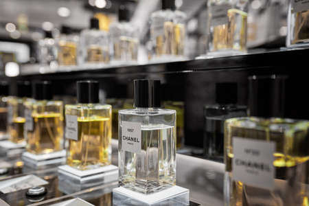 Female perfume Chanel No. 22 bottle closeup in store showcase. Perspective view of french Chanel perfume collection. Product from Coco Chanel in Rinascente. Milan, Italy - December 15, 2020.のeditorial素材