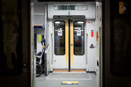 Doors of wagon in railway station of Milan, electric train carriage interior with an open sliding mechanical door at a train station platform. Milan, Italy - December 15, 2020のeditorial素材