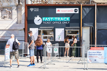 Milan, Italy - July 20, 2020: People standing in queue near ticket office of Museum of the Milan Cathedral. Visitors or tourists waiting to buy ticketのeditorial素材