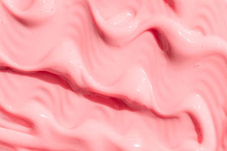 Peach cream, moisturizer, shampoo spread, sunscreen cosmetic smear background. Creamy pink skincare lotion mousse product closeup. Moisturizing beauty creme, balm swatch, pink paint, yogurt textureの写真素材