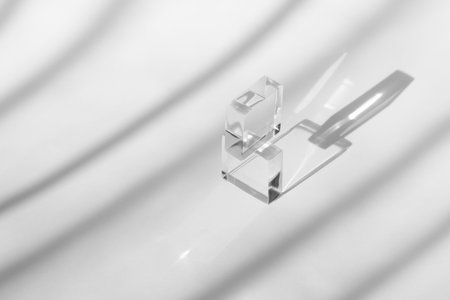 Cosmetic background for product presentation with room shadows and light from windows. Grey backdrop...