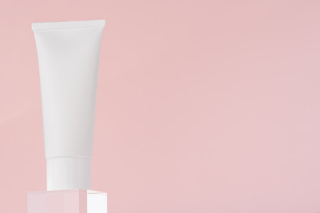 Beauty treatment medical skincare and cosmetic lotion cream serum oil mockup bottle packaging product on pink decor background, low angle view. Cosmetics template on acrylic pedestalの写真素材