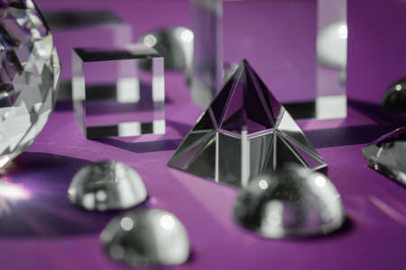 Crystal prism refracting light, magic crystals and pyramid, sphere and cube on purple background. Spiritual healing crystal practice. Feng Shui, good energy flow concept, esoteric background..の写真素材