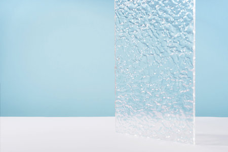 Acrylic ribbed plate, background for cosmetic product packaging on blue backdrop. Showcase for...