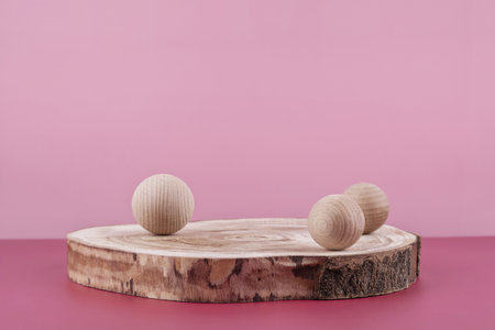 Background for cosmetic product presentation, wooden podium showcase on pink backdrop for cosmetics perfume and jewellery display with stylish props. Empty stage pedestal for beauty productsの写真素材