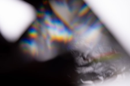 Blue light flare prism rainbow flares overlay effect on black background, light crossing crystals,...