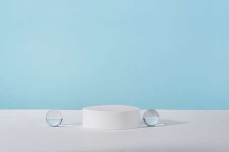 Showcase for jewellery presentation, display for advertising, cosmetics branding scene mockup. Acrylic plate, podium, background for cosmetic product packaging on blue backdrop with stylish props.の写真素材