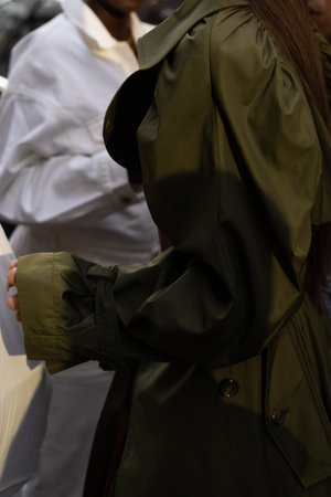 Milan, Italy - September, 21, 2022: Street style outfit details, woman wearing khaki puffy shirt sleeves, long belted coatのeditorial素材