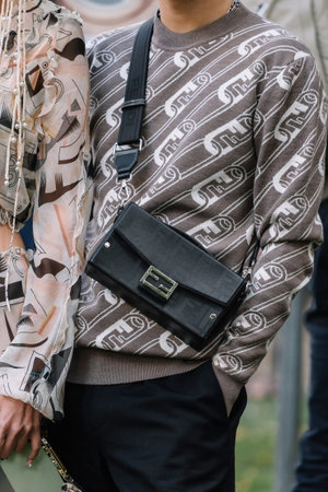 Milan, Italy - September, 21, 2022: Stylish man and woman wearing skirt, top and bags from fendi,...