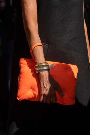 Milan, Italy - September, 22, 2022: woman wearing orange handbag, street style outfit detailsのeditorial素材
