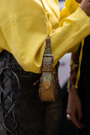 Milan, Italy - September, 21, 2022: woman wearing BY FAR Amira metallic-effect tote mini bag, street style outfit details.のeditorial素材