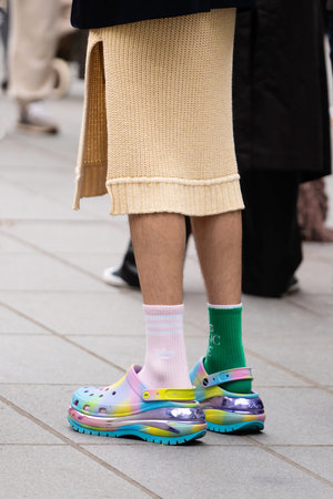 Paris, France - October, 3, 2022: man wears Lazy Oaf and Crocs collaboration pairs of clogs, street...