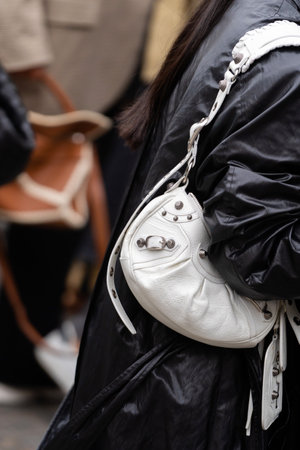 Paris, France - October, 3, 2022: woman wears white Cagole S leather shoulder bag from Balenciaga, street style details.のeditorial素材