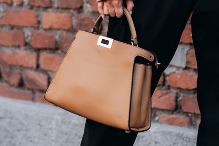 Milan, Italy - February, 23, 2022: woman wears leather Kelly Hermes bag, street style detailsのeditorial素材