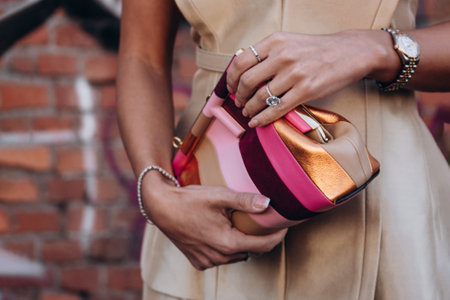 Milan, Italy - February, 23, 2022: woman wears leather Fendi multicolor stripe suede First Small bag, street style detailsのeditorial素材