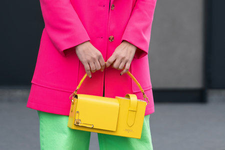 Milan, Italy - February, 24, 2022: woman wears yellow leather bag, street style detailsのeditorial素材