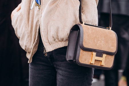 Paris, France - October, 3, 2021: woman wears handbag Velours Cotele Swift Constance 24 Tabac Camel Ebene, street style detailsのeditorial素材