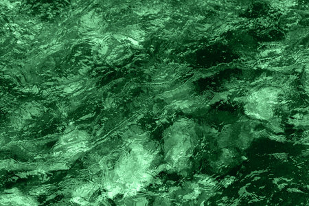 Abstract underwater wallpaper. Aquatic ripple wavy green water surface, water texture background,...