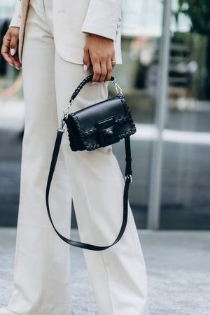 Milan, Italy - June, 19, 2022: woman wears black leather crown me bag from Etro, street style accessories.のeditorial素材